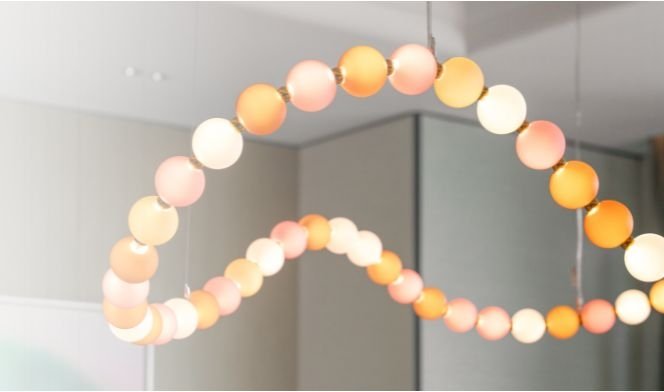 Modern chandelier made of colorful spheres in an interior.