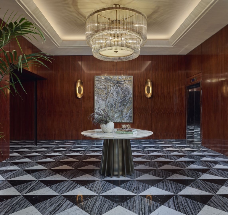Luxurious interior featuring an elegant chandelier and modern art in the background.