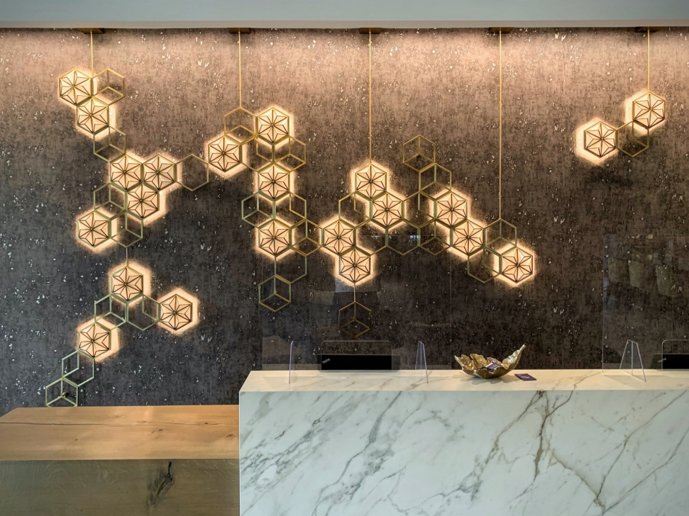Decorative hexagonal metal elements above the reception desk