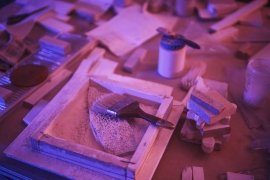 Artistic workspace with painting tools and colorful textures.